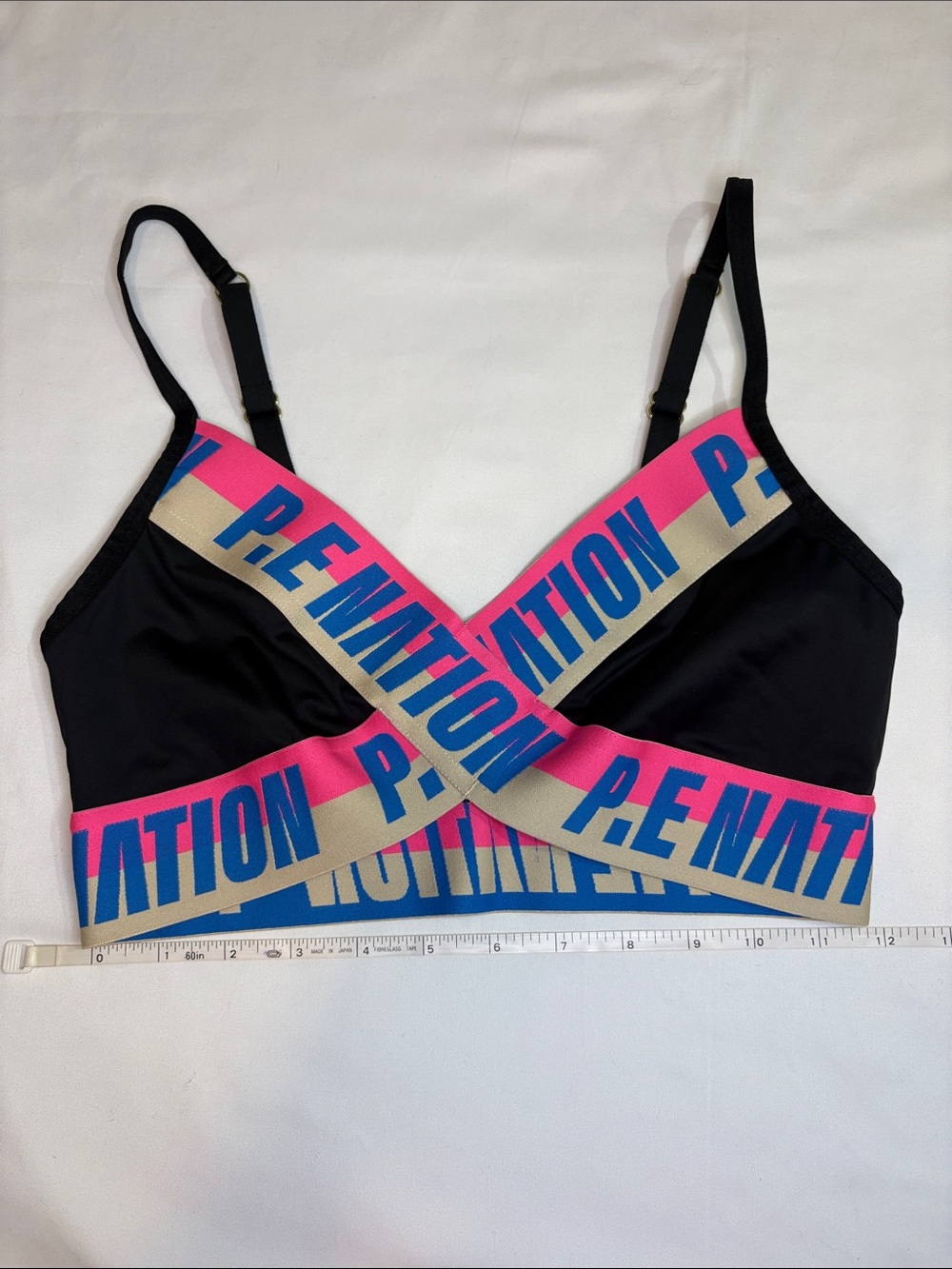 P.E Nation Half Volley Sports Bra Black Thick Band Logo Pink and Blue Text